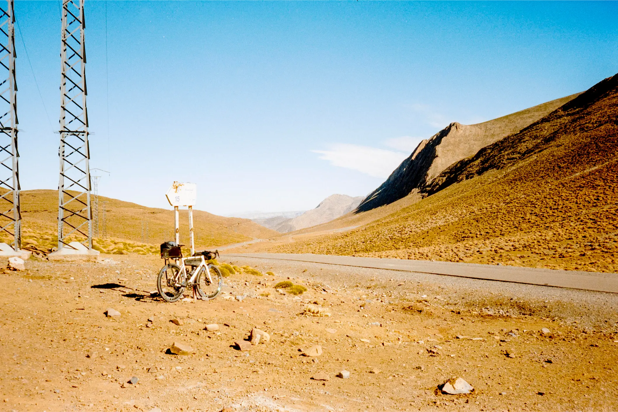 Bicycle at a road sign on a summit in the Atlas, Kodak film