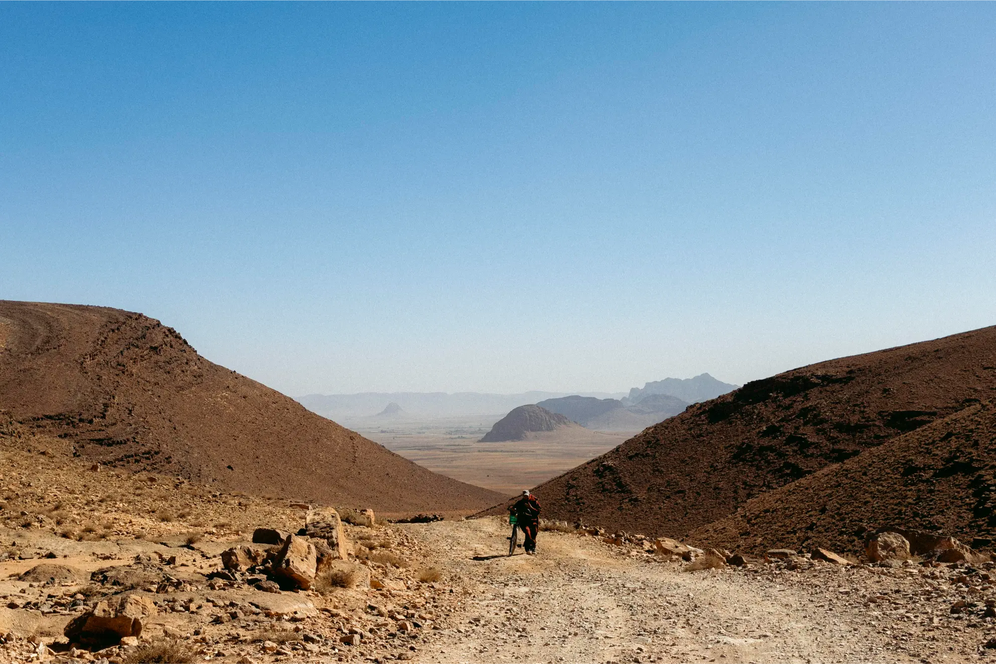 A stranger pushing his bicycle uphill in the Atlas Mountains