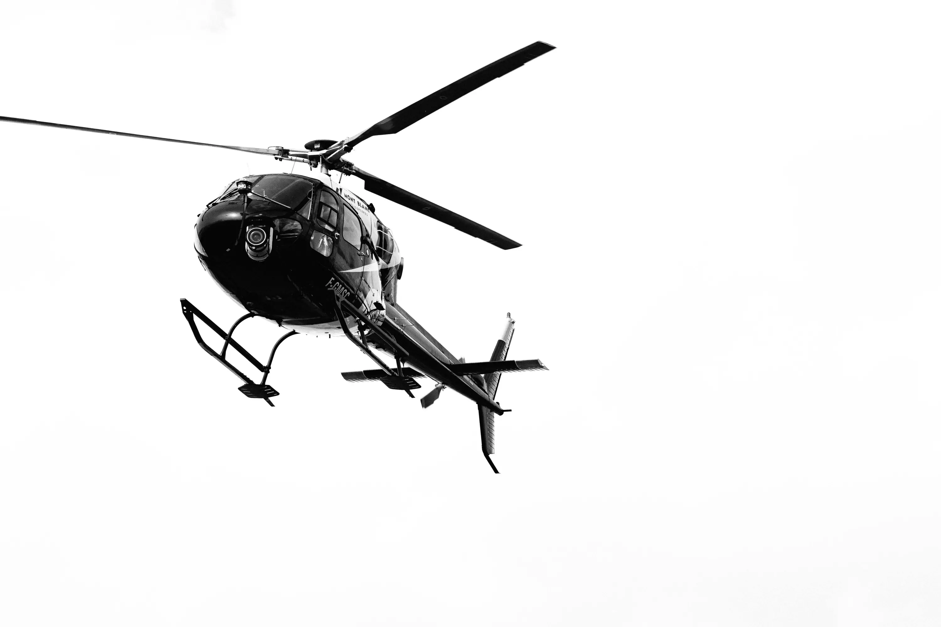 A single helicopter hovering above the race