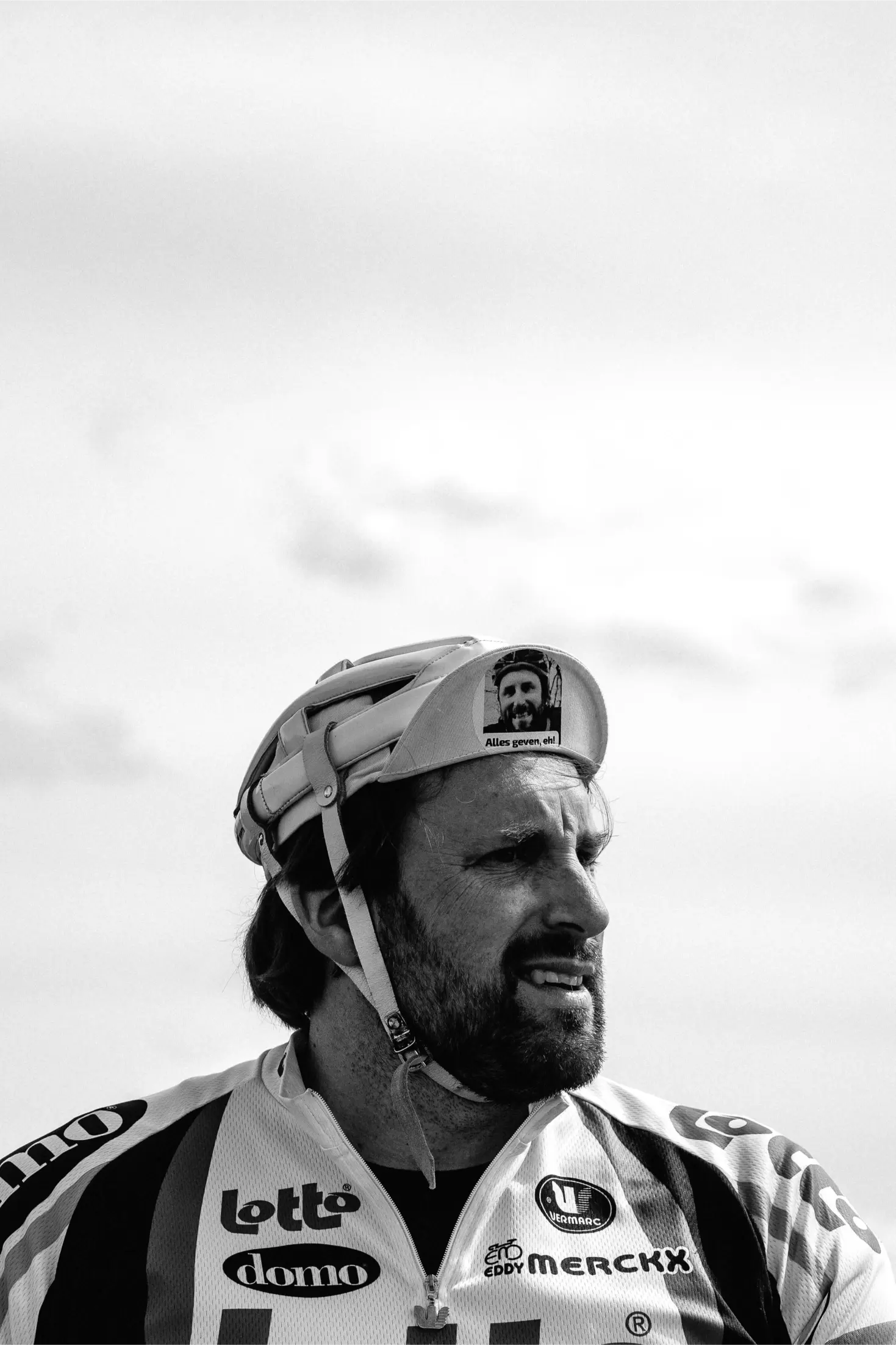 Portrait of a man wearing an old-fashioned helmet — a classic race fan