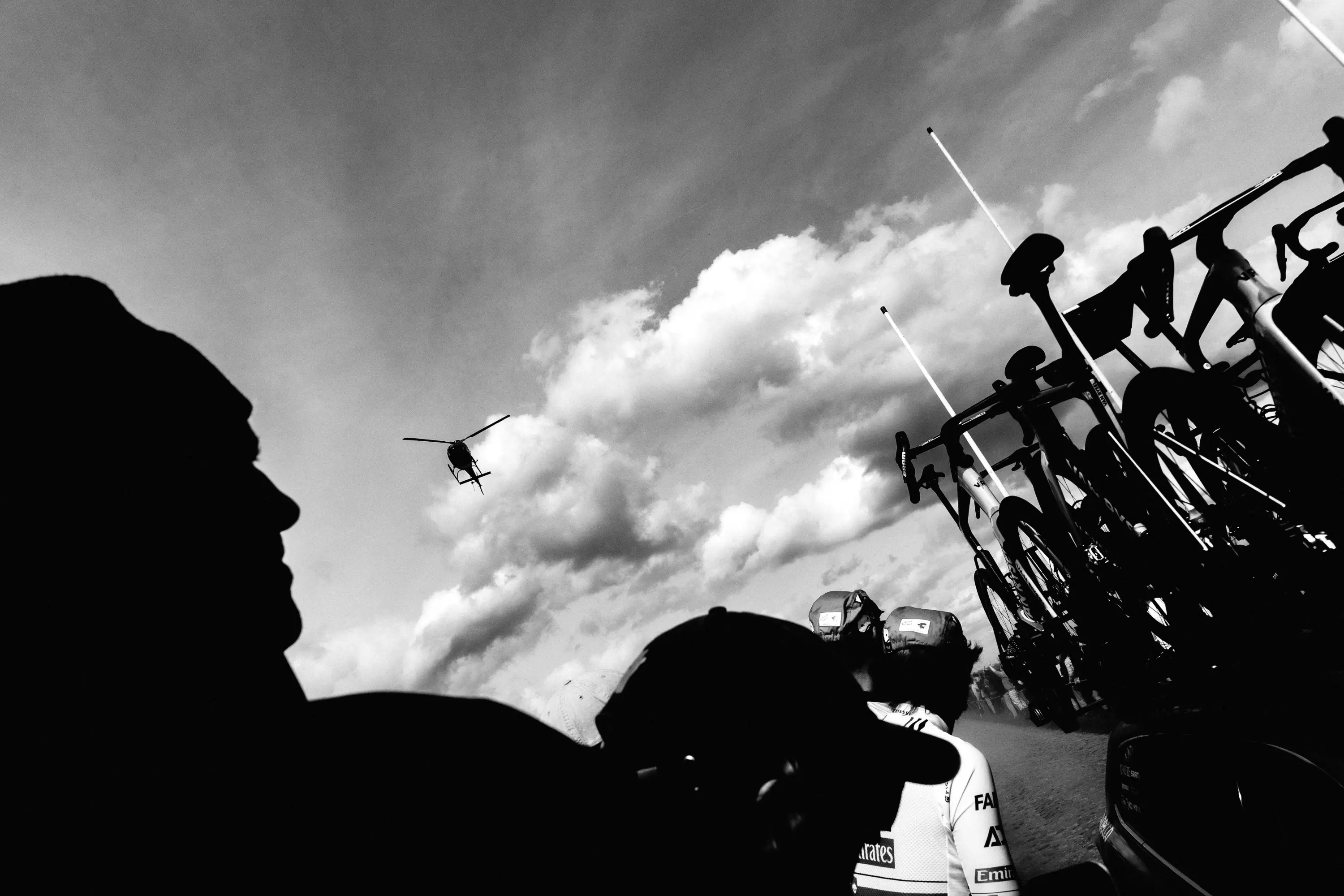 Chaos at the roadside: fans, a team car, and a helicopter all caught in a single frame